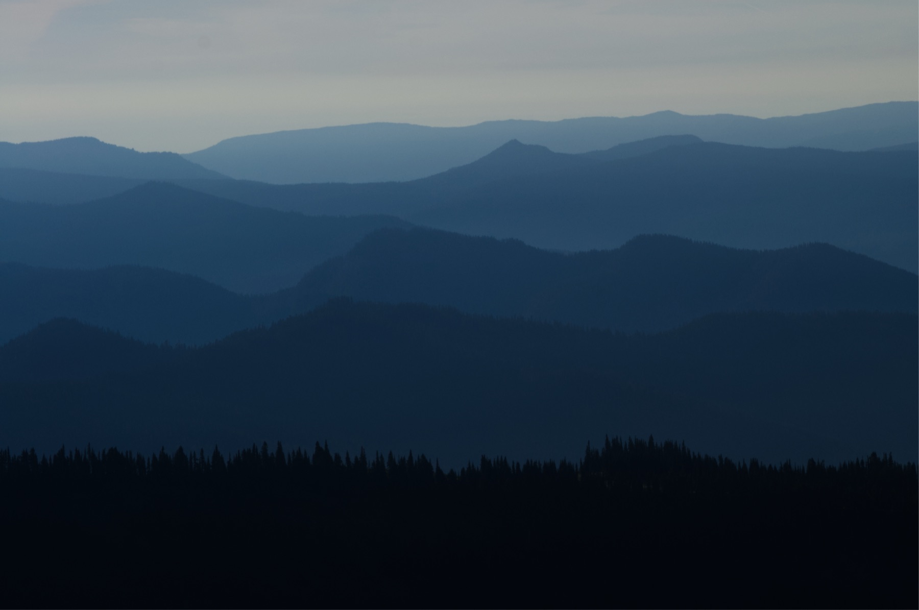 Layered mountain ridgelines in haze