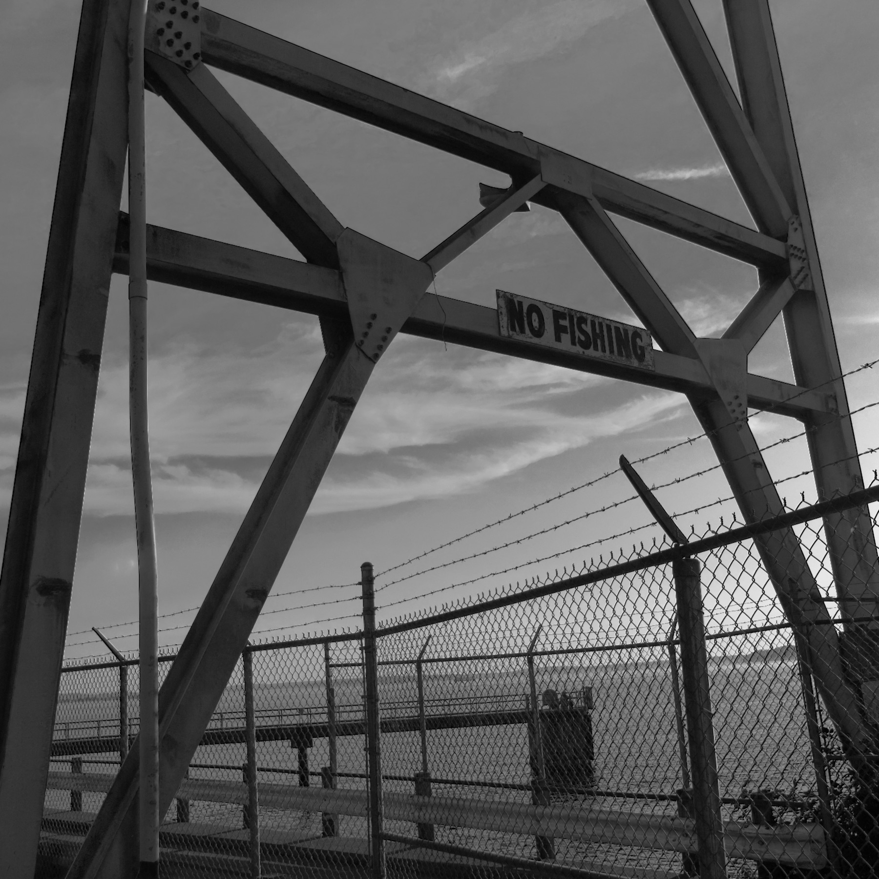 Bridge tower with a No Fishing sign, black and white