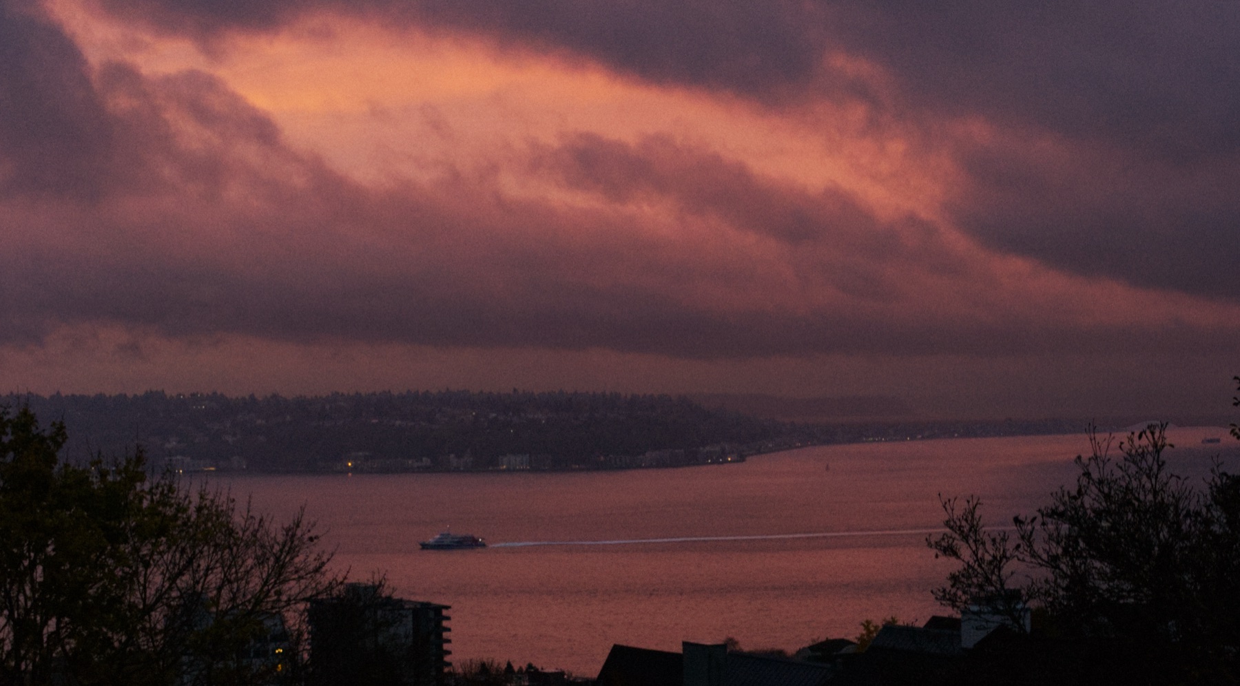 Sailboat silhouette at sunset over Puget Sound